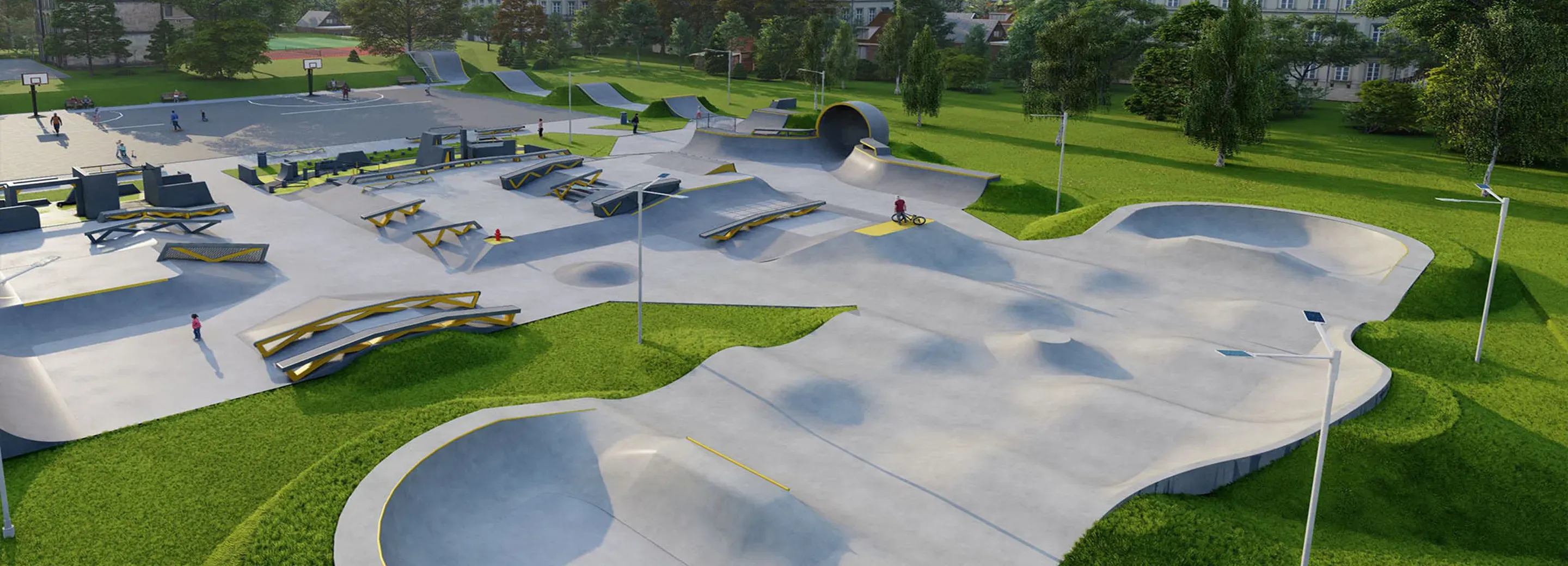 Skatepark z betonowymi rampami, poręczami i przeszkodami, otoczony trawą i drzewami.